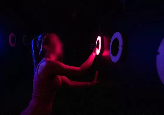 1. Players are positioned around the wall, each responsible for controlling one or more target holes.