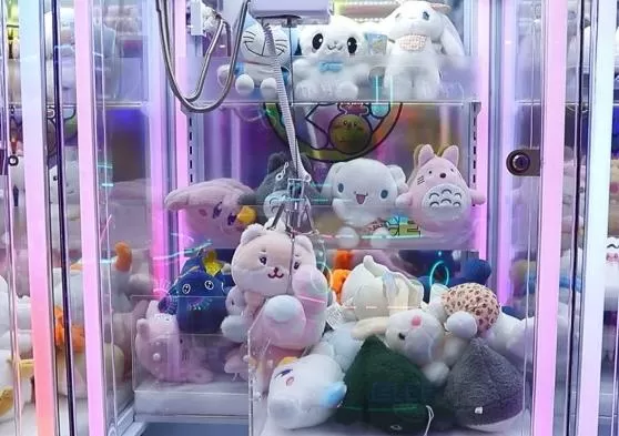 2. Use the joystick to control the claw reaching above the gift you like