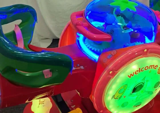 2. Take Your Seats: Each child sits comfortably in one of the two red bunny seats, holding onto the secure grips for stability.