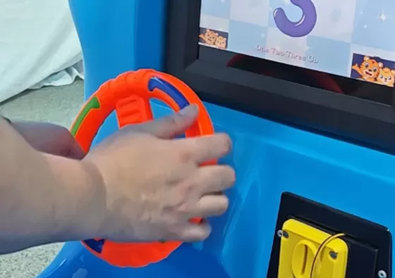 2. Mount Securely: Children sit comfortably on the motorcycle seat, gripping the handlebars for stability during the ride.