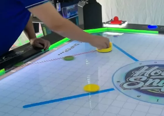 2. Control the Mallet, Attack & Defend: Rotate the handle to move your mallet and shoot the puck into the opponent's goal to score. Defend by sliding your mallet to block shots. Quick rebounds...