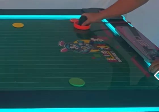 2. Control the Mallet, Attack & Defend: Rotate the handle to move your mallet and shoot the puck into the opponent's goal to score. Defend by sliding your mallet to block shots. Quick rebounds...