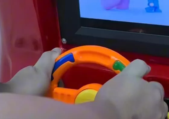 2. Mount Securely: Children sit comfortably in the red fire truck, holding onto the secure grips for stability during the ride.