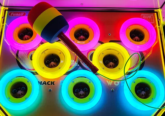 1. Classic Whack-a-Mole Challenge: Players strike randomly emerging targets within a time limit, earning points that translate into prizes dispensed from the central pole.