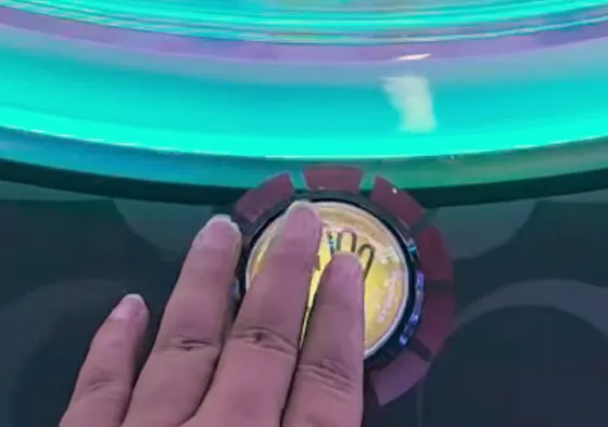 2. Turn the Handle: Rotate the handle to release a capsule from the machine.